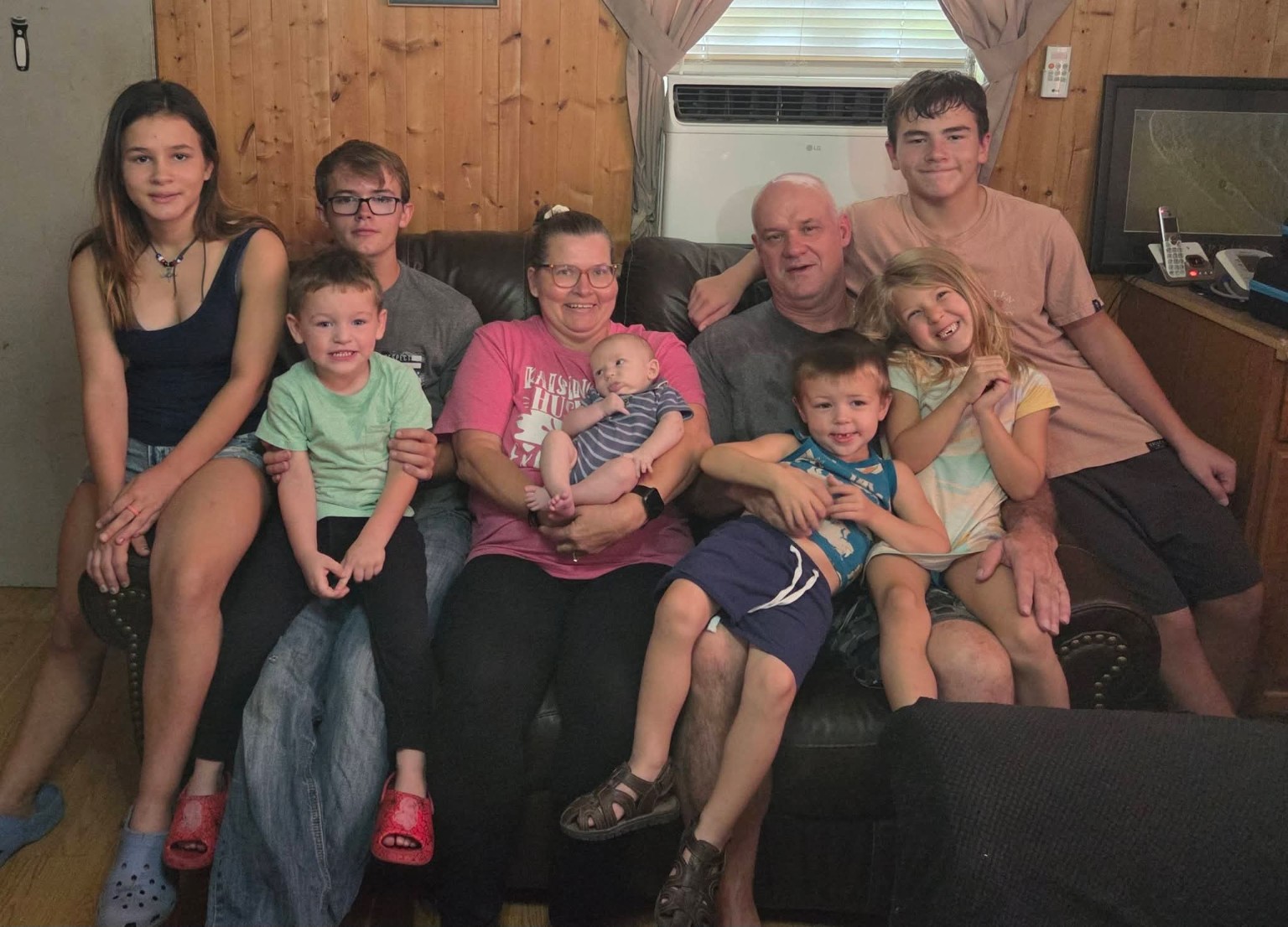 Margie surrounded by family during a relaxed gathering